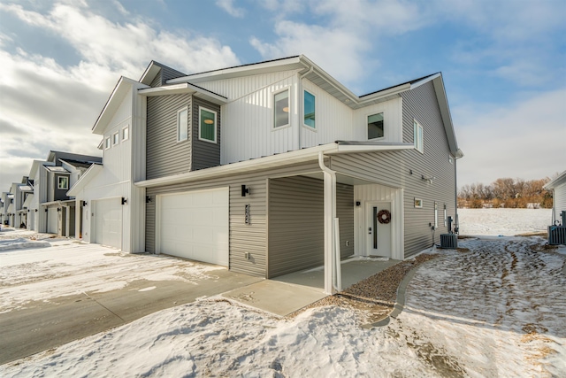 view of front of house with central AC unit and a garage