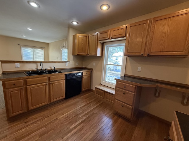 kitchen featuring dishwasher, sink, dark wood-type flooring, and built in desk