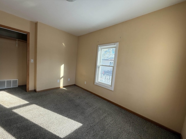 unfurnished bedroom featuring a closet and carpet