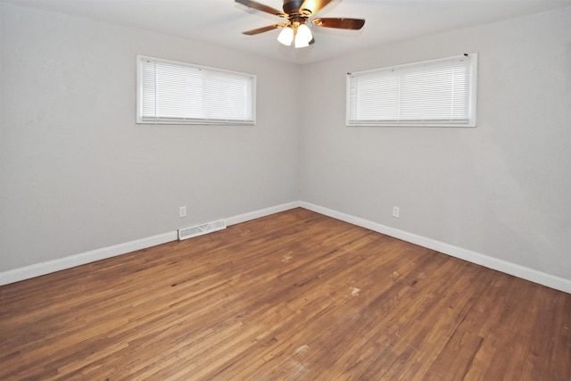 spare room featuring hardwood / wood-style floors and ceiling fan