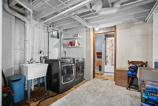 clothes washing area featuring sink and independent washer and dryer