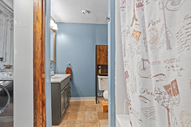 bathroom featuring walk in shower, toilet, a textured ceiling, vanity, and washer / clothes dryer