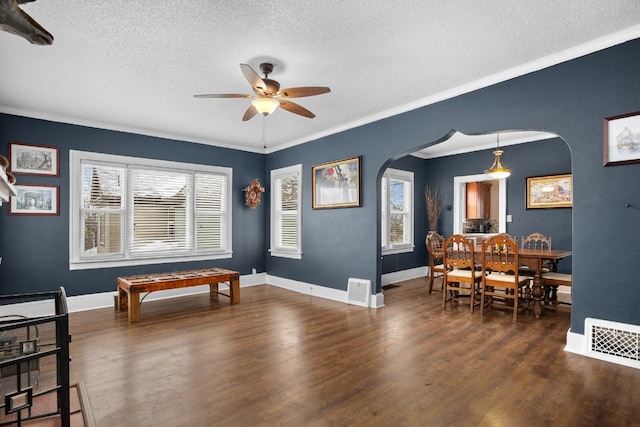 interior space with ornamental molding, dark hardwood / wood-style floors, and a wealth of natural light