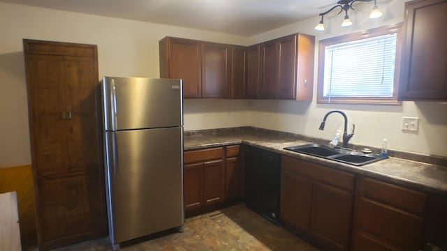 kitchen featuring stainless steel refrigerator, dishwasher, and sink