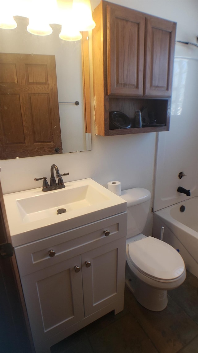 bathroom featuring vanity, tile patterned floors, and toilet