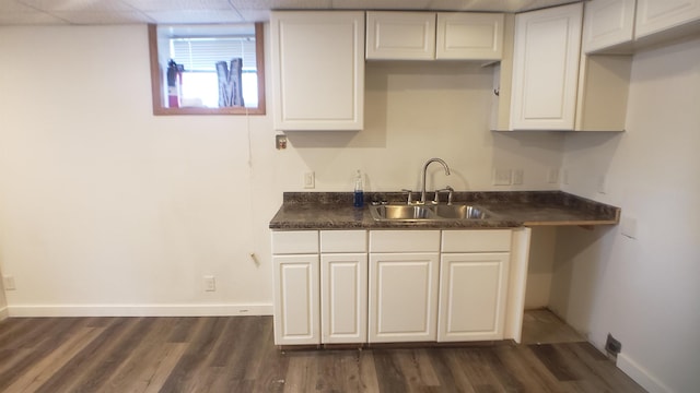 kitchen featuring white cabinetry, sink, and dark wood-type flooring