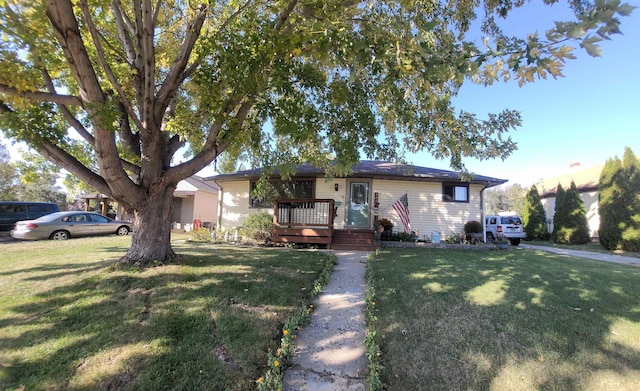 ranch-style home with a front yard and a deck