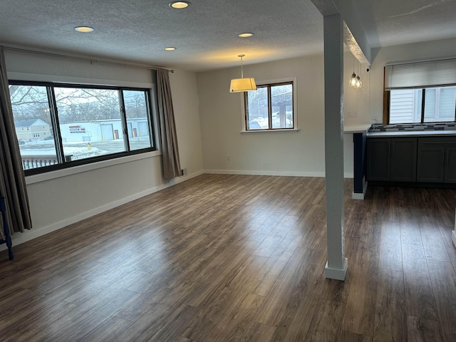 unfurnished room with dark wood-type flooring and a textured ceiling