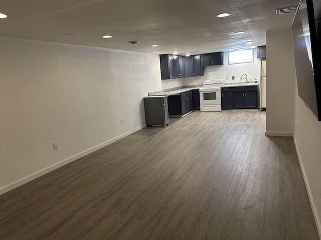 kitchen with fridge, sink, white electric range oven, and light hardwood / wood-style floors