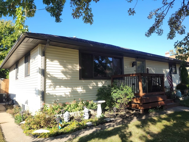 view of front of property featuring cooling unit and a deck