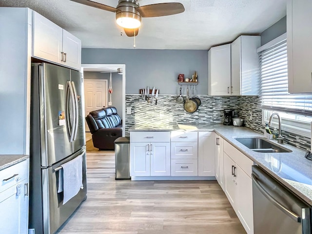 kitchen featuring white cabinetry, stainless steel appliances, and sink