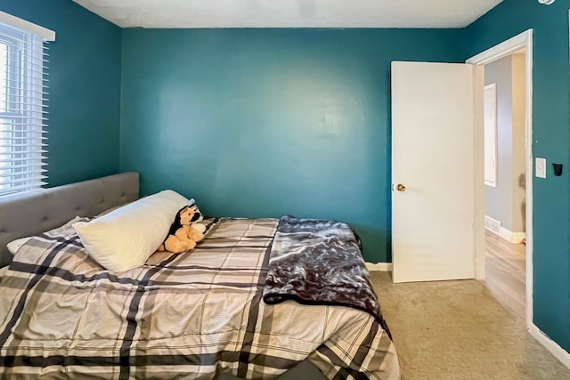 bedroom featuring light carpet