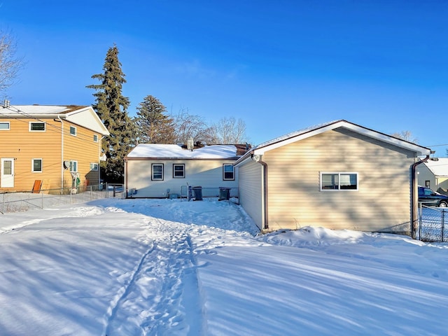 view of snow covered rear of property