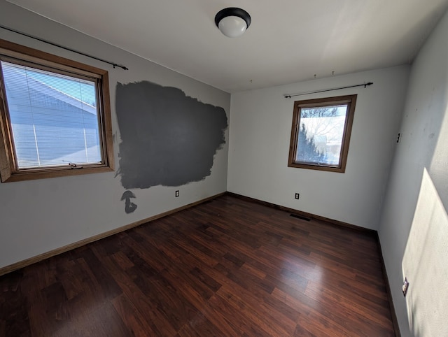 empty room with dark hardwood / wood-style floors