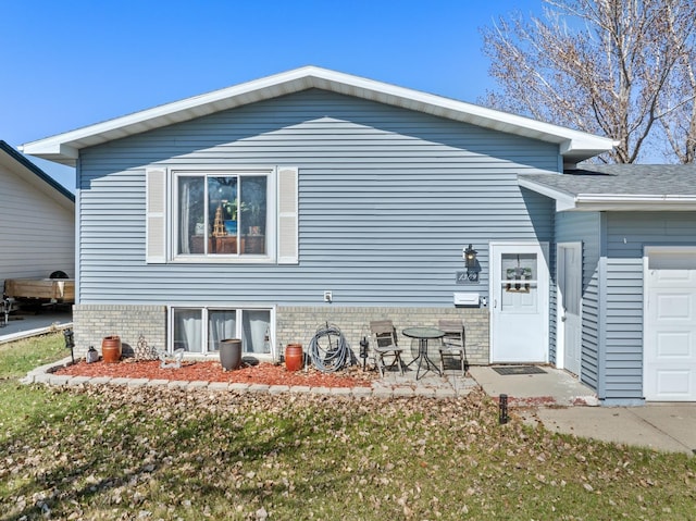 view of property exterior with a garage and a lawn