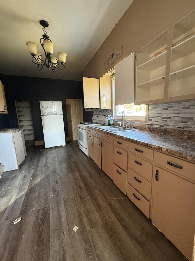 kitchen featuring sink, white appliances, dark wood-type flooring, and decorative light fixtures