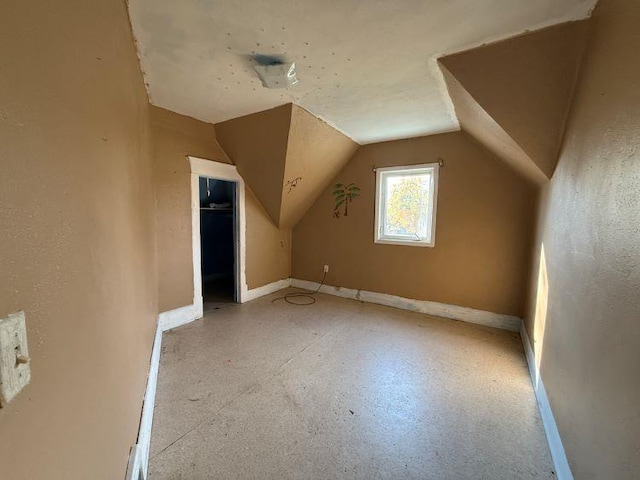 additional living space featuring vaulted ceiling