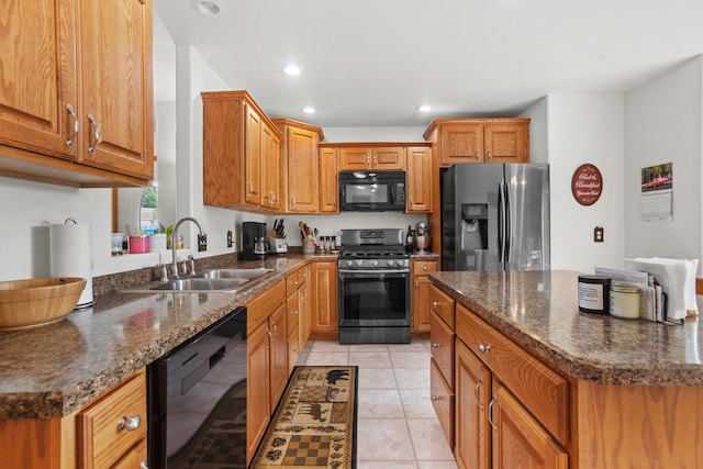 kitchen featuring light tile patterned flooring, sink, dark stone countertops, and black appliances