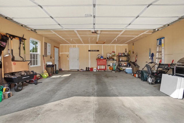 garage with a garage door opener and electric panel