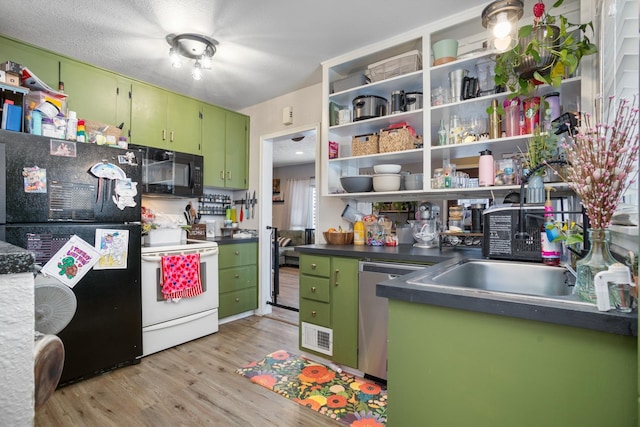 kitchen featuring green cabinetry, light wood-type flooring, and black appliances