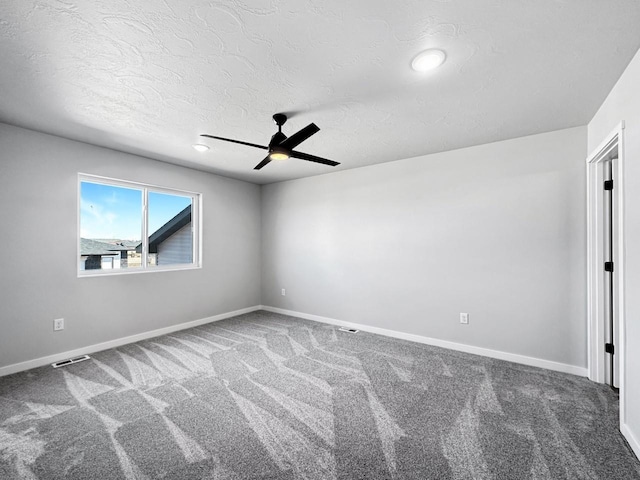 empty room with carpet floors, a textured ceiling, and ceiling fan