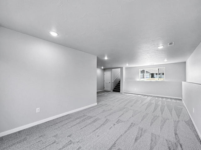 interior space with light colored carpet and a textured ceiling