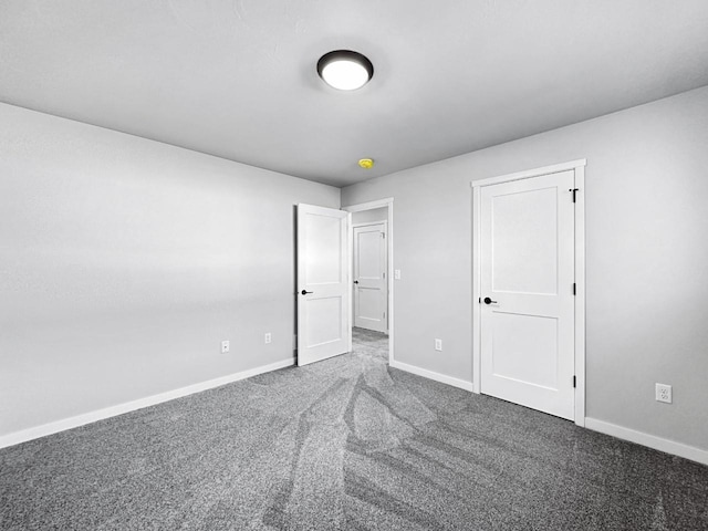 unfurnished bedroom featuring dark carpet