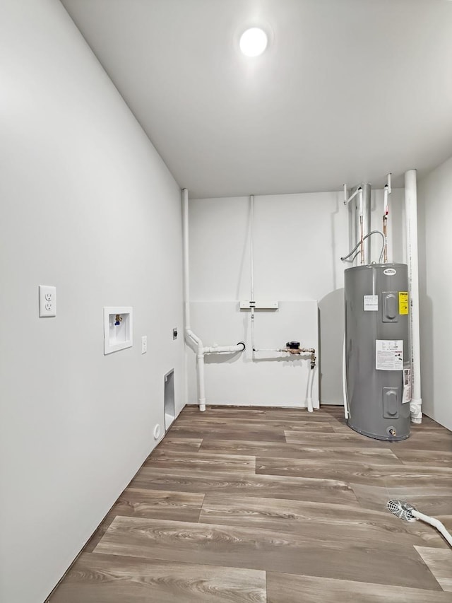 laundry area featuring hardwood / wood-style flooring, hookup for an electric dryer, hookup for a washing machine, and electric water heater