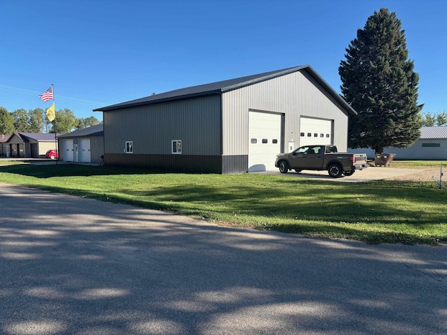 exterior space featuring a garage and a yard