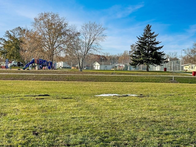 surrounding community featuring a playground and a lawn