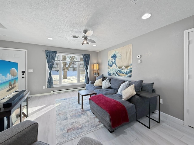 living room featuring a textured ceiling, hardwood / wood-style flooring, ceiling fan, and baseboard heating