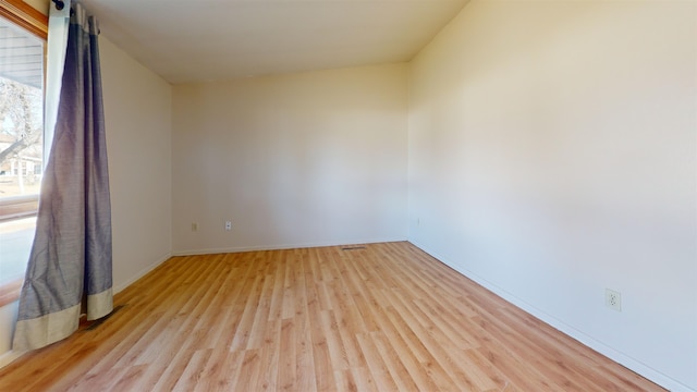 empty room with light hardwood / wood-style flooring