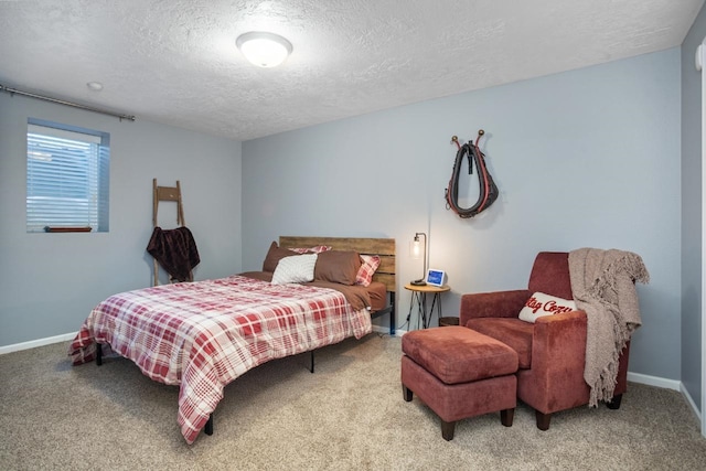 bedroom with a textured ceiling, baseboards, and carpet flooring