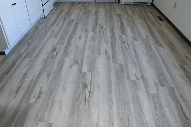 room details with visible vents, baseboards, and wood finished floors