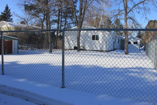 snowy yard with fence