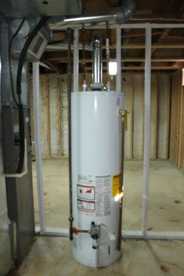 utility room featuring water heater