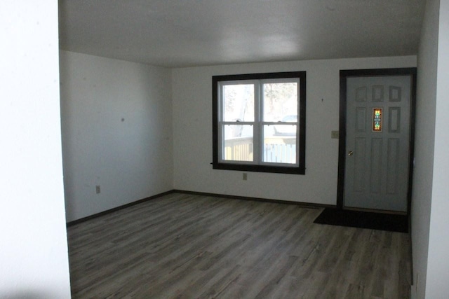 foyer entrance featuring dark wood finished floors and baseboards