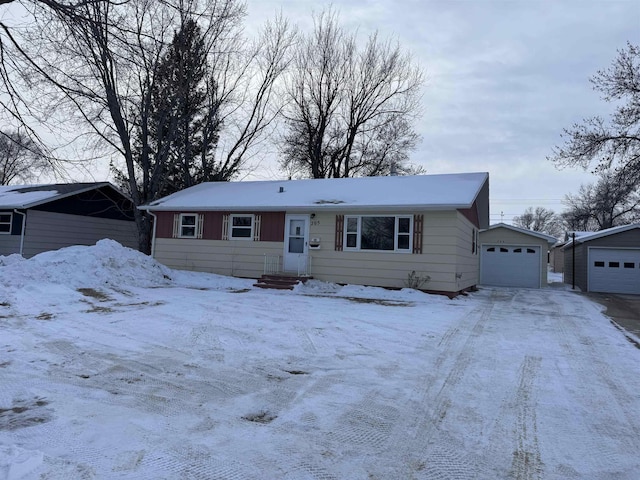 view of front of home with an outdoor structure and a detached garage