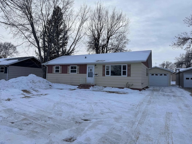 view of front of property featuring a garage, driveway, and an outdoor structure