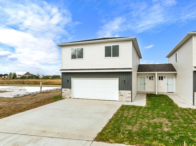 view of front of home featuring board and batten siding, stone siding, concrete driveway, and a garage