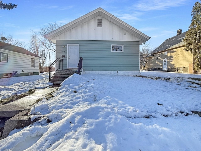 view of snow covered rear of property