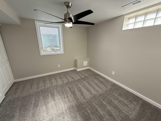 unfurnished bedroom featuring a textured ceiling, carpet flooring, visible vents, and baseboards