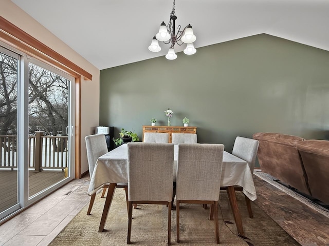 dining space with vaulted ceiling and a notable chandelier