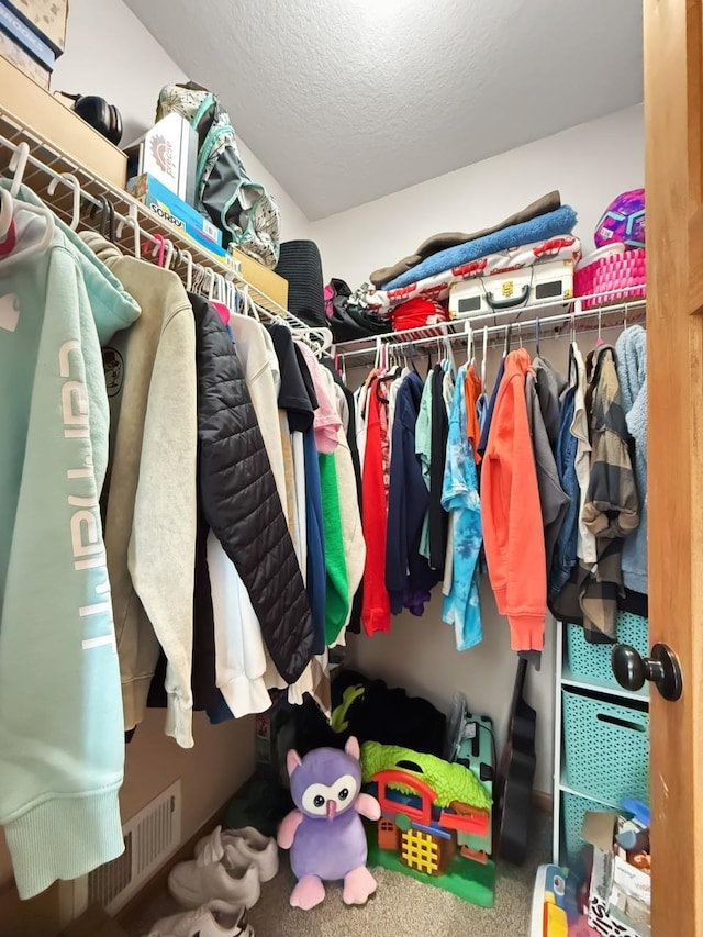 walk in closet with carpet and visible vents