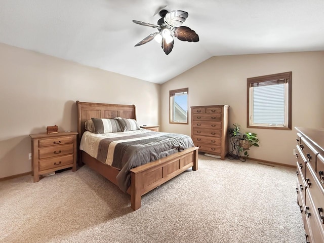 bedroom with ceiling fan, baseboards, vaulted ceiling, and light colored carpet