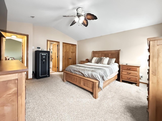 carpeted bedroom with vaulted ceiling and a ceiling fan