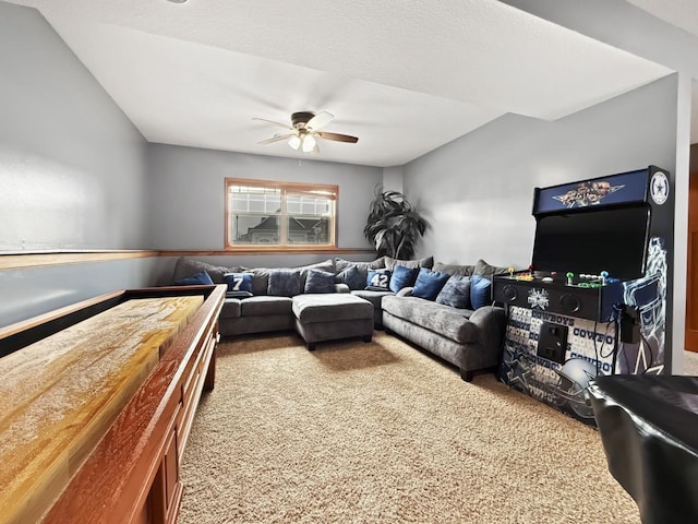 living room with a textured ceiling, carpet flooring, and a ceiling fan