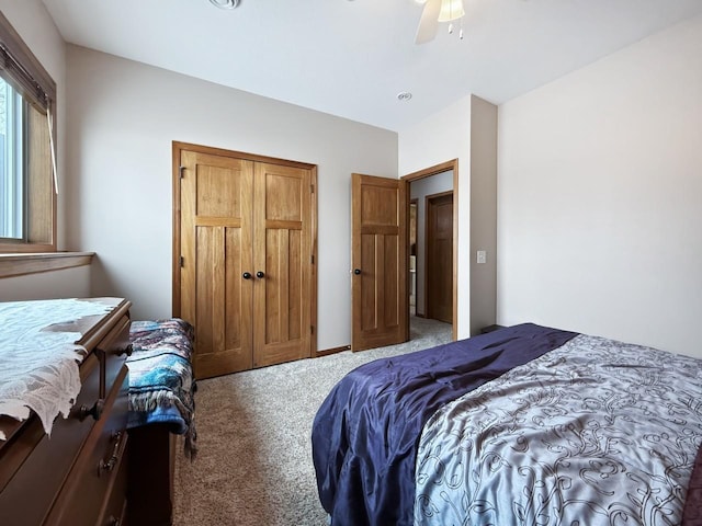 bedroom with carpet floors, a closet, and a ceiling fan