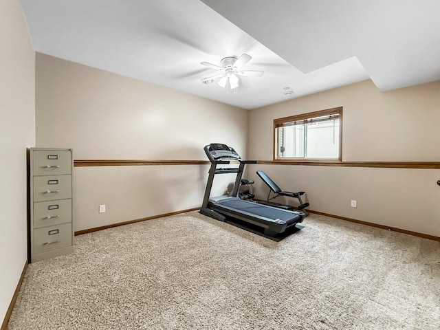 workout room featuring carpet floors, ceiling fan, and baseboards