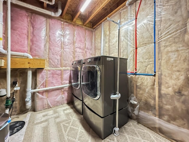 clothes washing area with laundry area and washer and clothes dryer